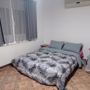 a bed sitting in a room with a window at Green house - Apartment in Aridaia-Loutra Pozar in Aridaia