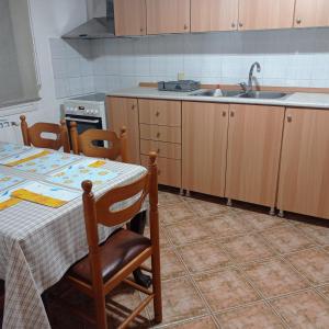 a kitchen with a table and a sink at Green house - Apartment in Aridaia-Loutra Pozar in Aridaia