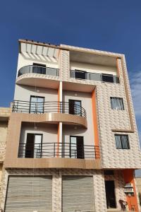 a building with balconies on the side of it at Studio Moderne Dakar Keur Ndiaye LÔ in Dakar