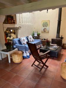 a living room with a couch and a stove at Exclusiva casa rural con jardín in Madriguera