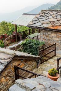 a stone building with a bench on the side of it at Chalet Palù in Brosso