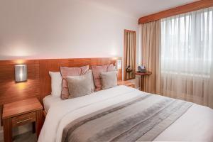 a bedroom with a large bed and a window at Conference Aston Hotel - Birmingham City in Birmingham