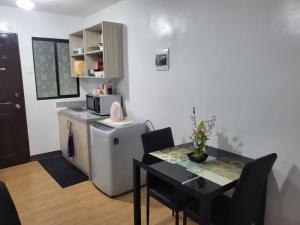a small kitchen with a table and a microwave at Kate Building in Imus