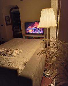 a bedroom with a bed and a flat screen tv at C'era una "volta"... un appartamento a Torino in Turin