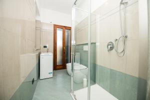 a bathroom with a toilet and a glass shower at ShortMi Montello in Milan