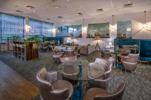 a lobby with a waiting room with chairs and tables at Conference Aston Hotel - Birmingham City in Birmingham