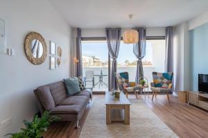 a living room with a couch and chairs and a table at Livia Studio Apartment in Larnaca in Larnaca