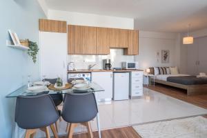a kitchen and living room with a table and chairs at Livia Studio Apartment in Larnaca in Larnaca