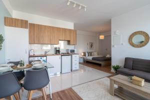 a kitchen and living room with a table and chairs at Livia Studio Apartment in Larnaca in Larnaca