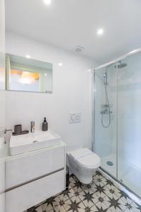 a bathroom with a toilet and a sink and a shower at A Window to Porto - Pestana charming flat in Porto +33 photos
