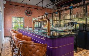a bar with a row of bar stools at Taj Holiday Village Resort & Spa, Goa in Candolim
