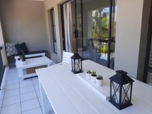 a white table with potted plants on top of it at Studio @ 32 in Ballito
