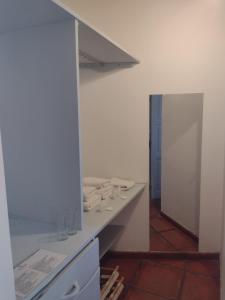 a kitchen with a counter with glasses on it at Pumahuasi Hotel Boutique in Purmamarca