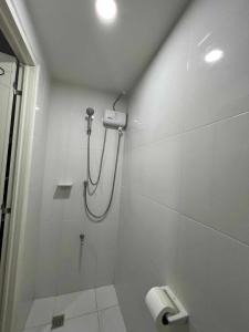 a bathroom with a shower and a toilet at Iza's Alabang Studio Apartment in Manila