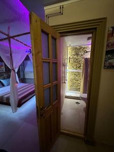 an open door to a bedroom with a canopy bed at City Center Beach side Hut in Tbilisi City