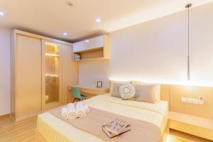 a bedroom with a bed with two towels on it at Sky Park Condotel & Residence in Siem Reap