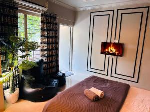a bedroom with a bed with a fireplace in it at The Studio: AC, WiFi, Smart Tv in Pune