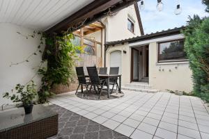 a patio with a table and chairs on it at Apartment Bodman in Friedrichshafen in Friedrichshafen