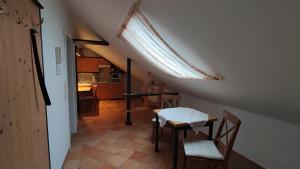 a room with a table and chairs and a kitchen at Ferienhof Fenzl in Pocking