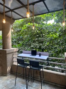 a table and two chairs sitting on a patio at The Studio: AC, WiFi, Smart Tv in Pune