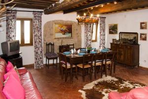 a dining room with a table and chairs and a tv at THE REAL TUSCANY in Casabasciana