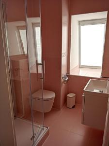 a bathroom with a shower and a toilet and a sink at Villa Rosali Boutique Hotel in Hamburg
