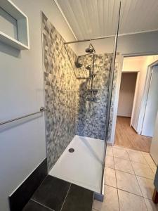 una doccia con porta in vetro in bagno di Bel appartement vue mer. a Les Issambres