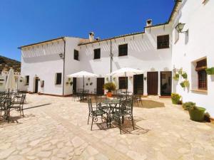 a courtyard with tables and chairs in front of a building at Cortijo La Presa in Priego de Córdoba