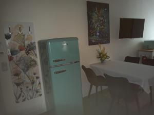 a dining room with a refrigerator and a table at Villa Rosali Boutique Hotel in Hamburg