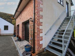 a brick building with a staircase next to a garage at Woodland View in Mold