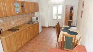 a kitchen with a table with chairs and a counter top at Apartments Rokytka - Praha in Prague