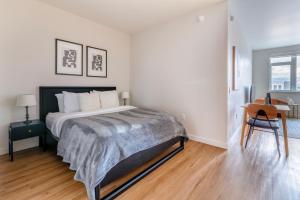 a white bedroom with a bed and a desk at Oakland 1br w gym ac nr bart nightlife SFO-1492 in Oakland