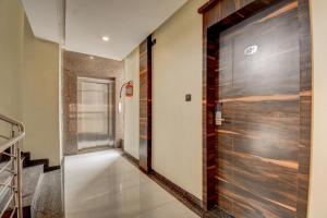 a hallway with a wooden door in a house at Hotel Deepali Executive in Aurangabad