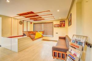 a kitchen with a counter and a couch in a room at Hotel Deepali Executive in Aurangabad