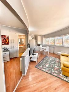 a kitchen and living room with a couch and a table at L'Appartamentino Montagna in Biella