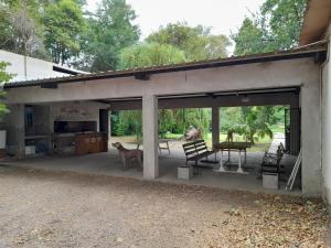 a garage with a table and a dog sitting on it at CASA DE CAMPO LA MAGNOLIA in Junín