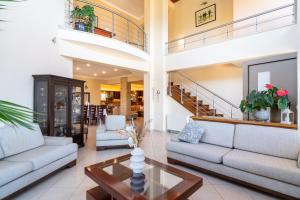 a living room with couches and a table at Kondarini Villa - Stunning Sea Views, 290m from the beach, by ZanteWize in Tsilivi