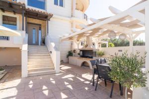 a patio with a wooden pergola and a grill at Kondarini Villa - Stunning Sea Views, 290m from the beach, by ZanteWize in Tsilivi +59 photos