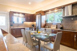 a kitchen with a table and chairs in a kitchen at Kondarini Villa - Stunning Sea Views, 290m from the beach, by ZanteWize in Tsilivi