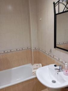 a bathroom with a sink and a bath tub at El rinconín de Luanco in Luanco