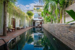 a swimming pool in the middle of a building at Victoria Central Residence in Siem Reap