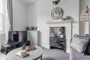 a living room with a table and a fireplace at Lovely apartment - Great Portland Street - LONDON ZOO - CENTRAL LOCATED in London