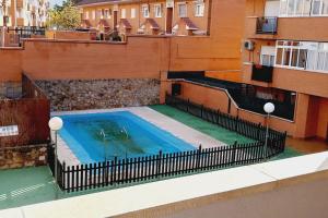 a swimming pool on the side of a building at Manzanares Getaway in Manzanares el Real