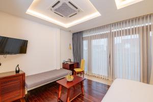 a hotel room with a bed and a tv at Victoria Central Residence in Siem Reap