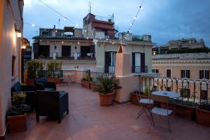a balcony with chairs and tables on a building at RoofRhome in Rome