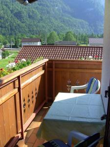 a balcony with a table and a view of a mountain at Haus Alpenrose Obertraun in Obertraun +32 photos