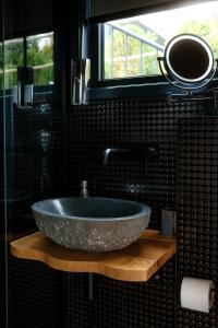 a bathroom with a large stone sink on a counter at HORIZONS of Bakurtsikhe in Bakurtsʼikhe