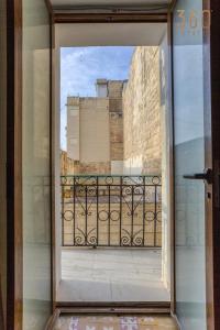an open door with a view of a balcony at A lovely, 1BR home with lovely views in Isla BY 360 Estates in Senglea