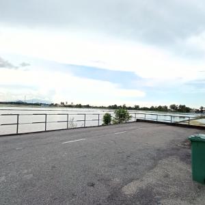 a parking lot next to a body of water at De'Bendang Homestay Pendang in Pendang