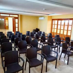 a room with rows of chairs in a room at Cancun International Suites in Cancún